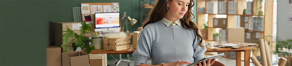 A person in an office preparing to ship USPS Ground Advantage packages.