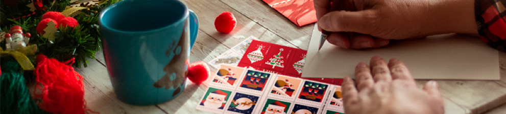 An assortment of holiday stamps ready to be put on holiday cards and letters.