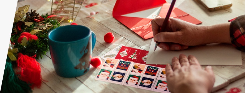 An assortment of holiday stamps ready to be put on holiday cards and letters.