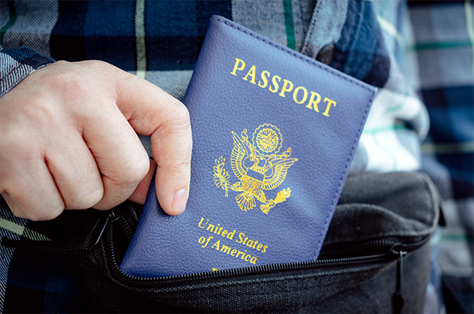 A person holding up a passport.