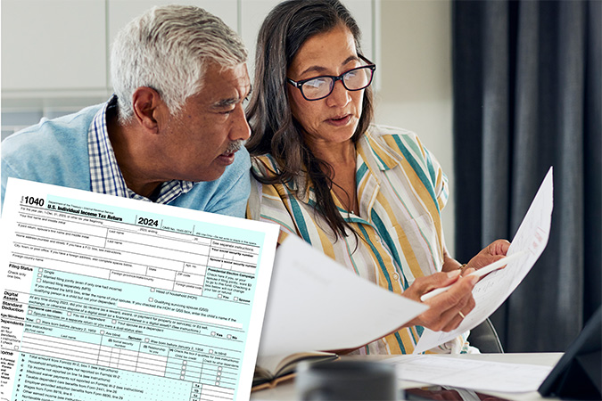 An IRS form 1040 and two people filling out tax forms together.