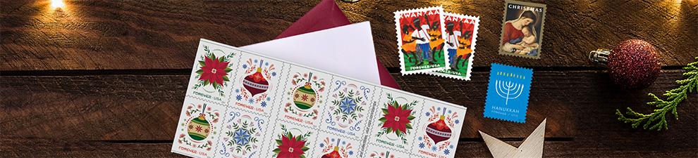 Holiday stamps for cards and letters on a table.